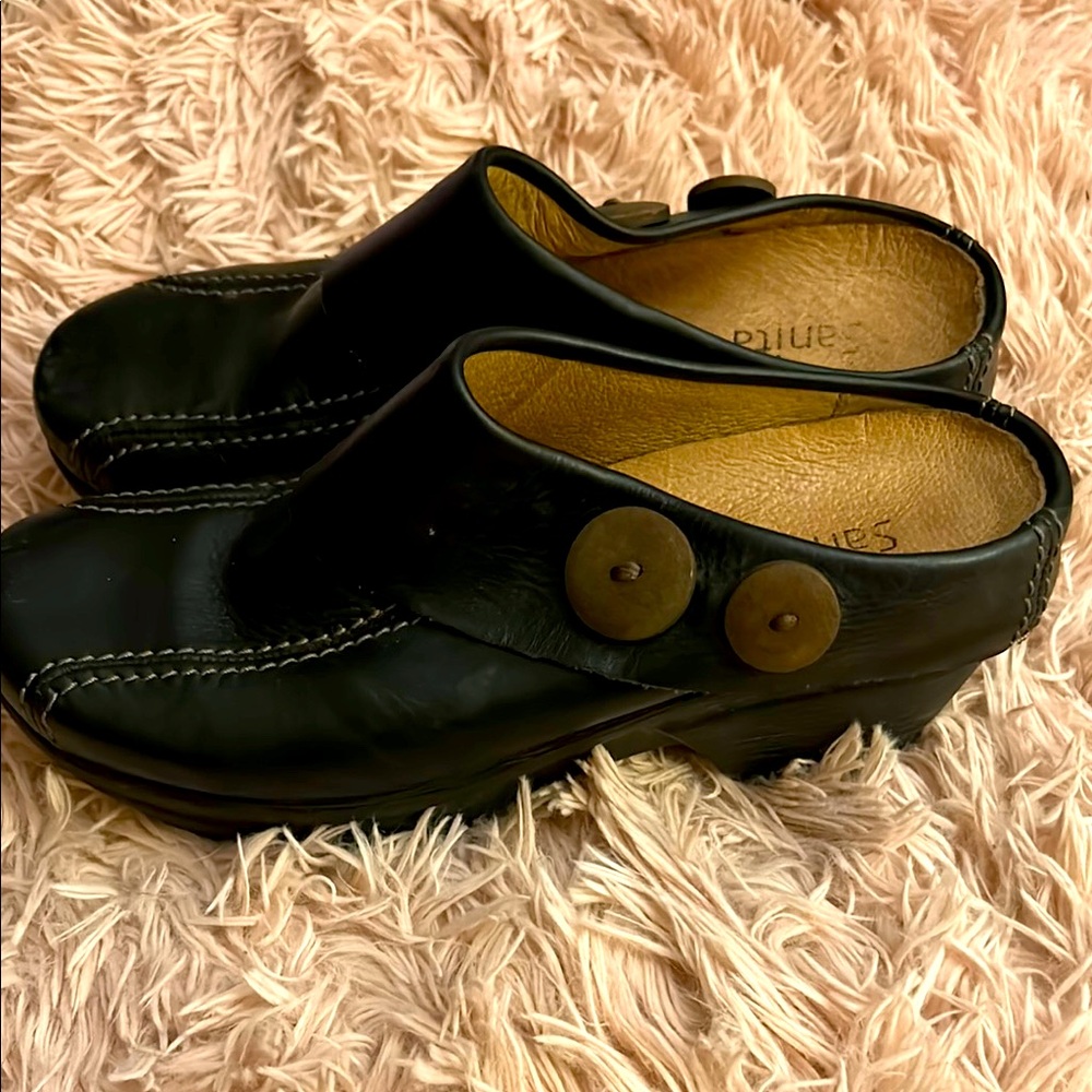 Sanita.   Black Leather Clogs with Button Detail
